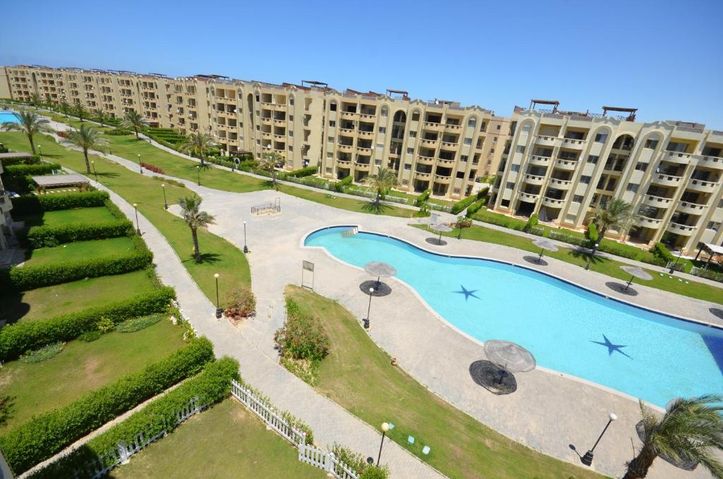 an aerial view of a large apartment complex with a swimming pool at ALFRDOUS LUXURY VACATION HOME NORTH COAST in Sīdī ‘Abd ar Raḩmān