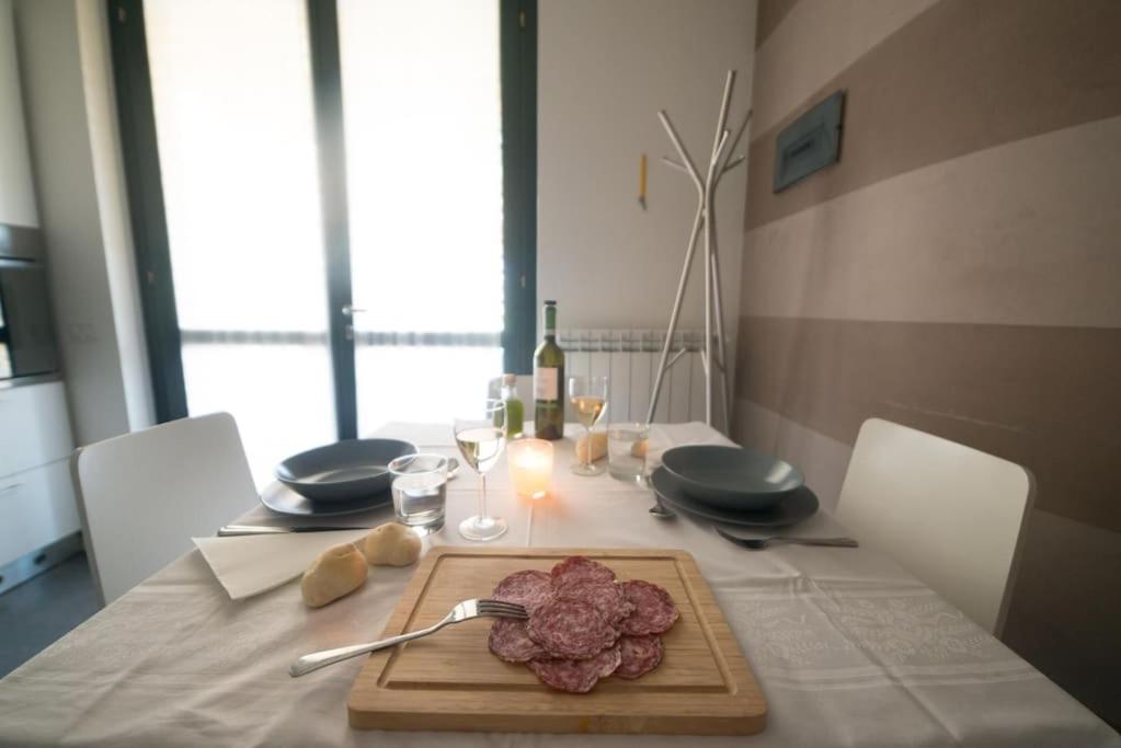 a table with a cutting board with meat on it at Un Angolo di Relax in Tavernola Bergamasca