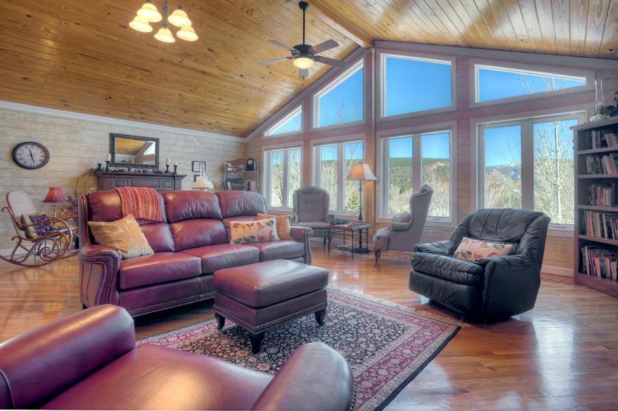 a living room with a leather couch and chairs at OReilly Inn in Durango