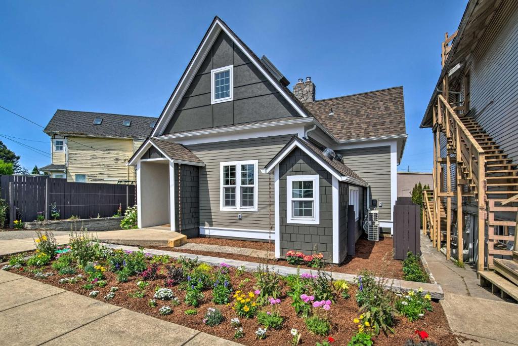 a house with a garden in the front yard at Renovated North Bend Cottage Near Eateries! in North Bend