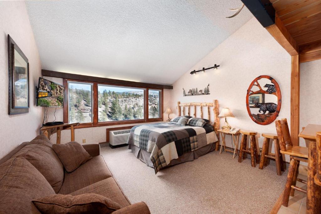 a bedroom with a bed and a couch at Tamarron Lodge Loft 506 in Durango