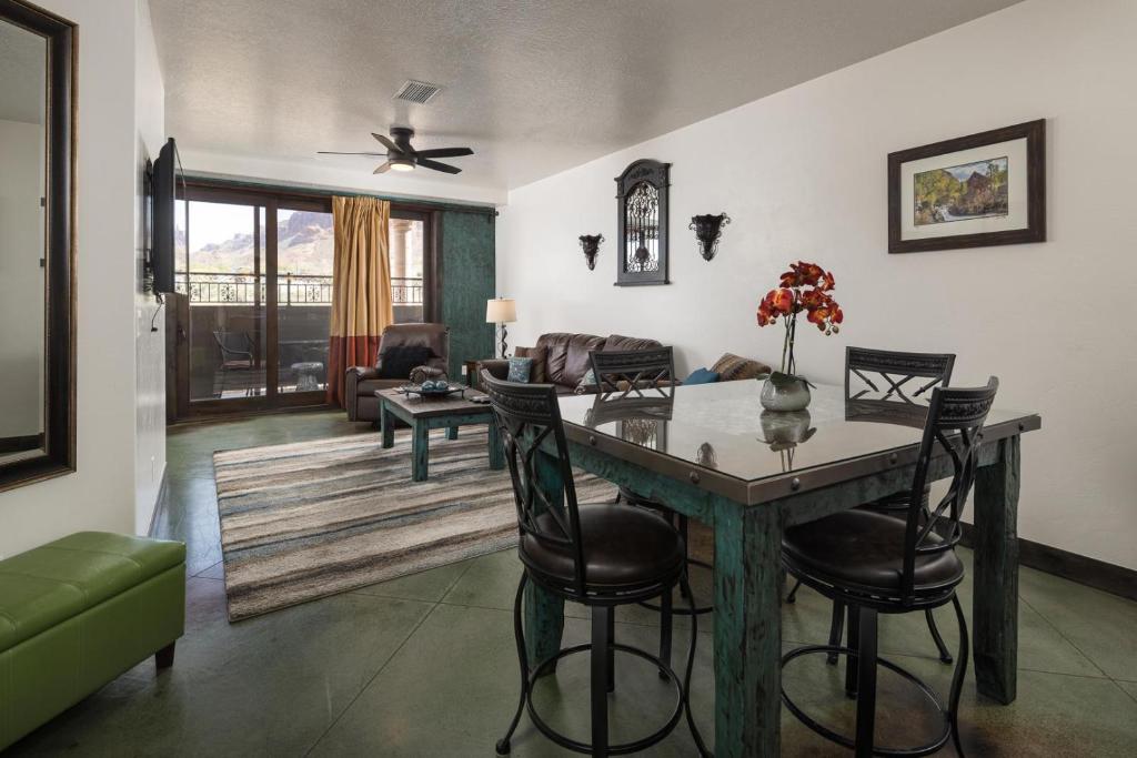a living room with a table and chairs and a couch at La Dolce Vita Villas 10 in Moab