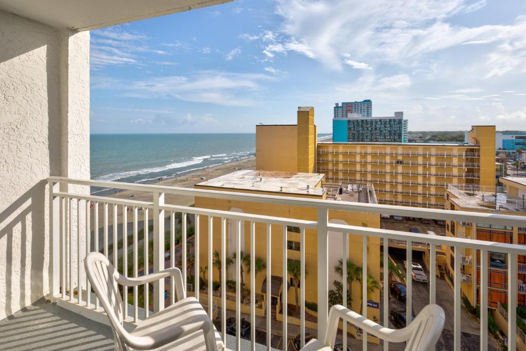 a balcony with two chairs and a view of the ocean at Driftwood 51009 in Myrtle Beach