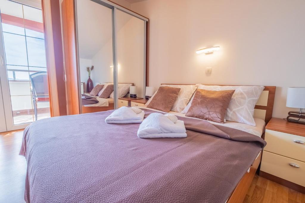 Postel nebo postele na pokoji v ubytování Apartments Laganini