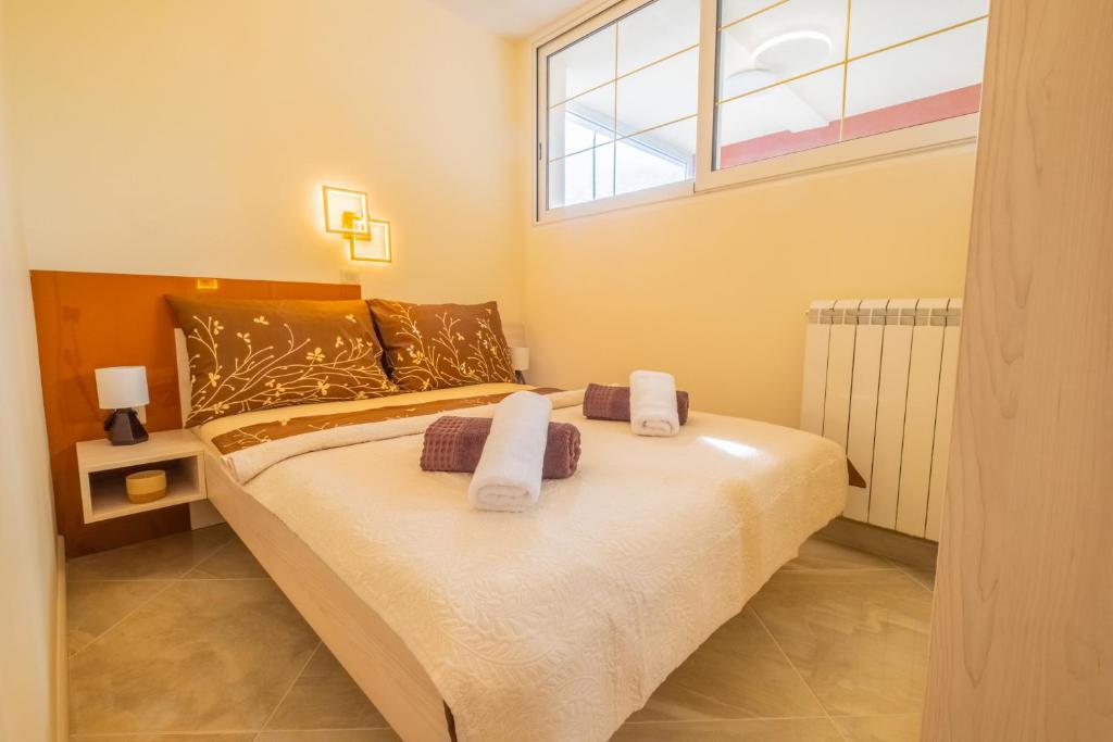 Postel nebo postele na pokoji v ubytování Apartments Laganini