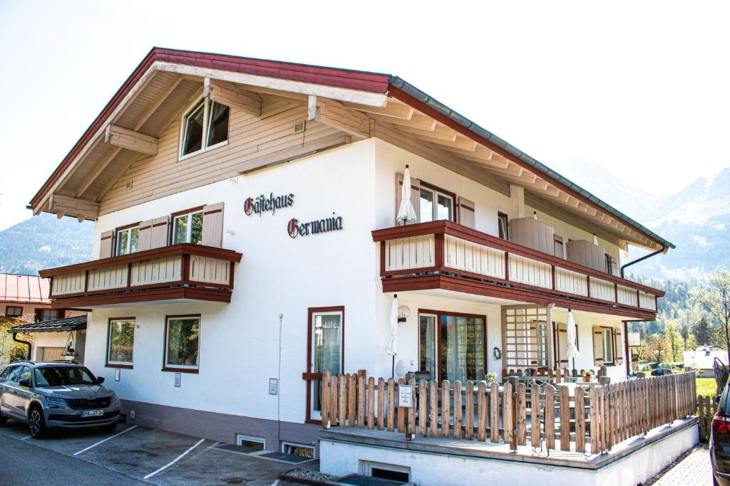 a building with a car parked in front of it at Gästehaus Germania in Schönau am Königssee