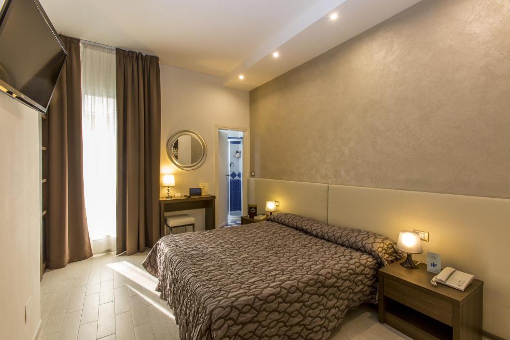 Postel nebo postele na pokoji v ubytování Hotel Touring