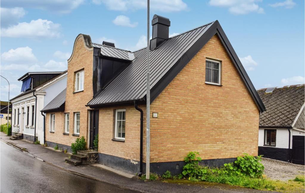 a brown brick house with a black roof at 4 Bedroom Cozy Home In Smedstorp in Smedstorp