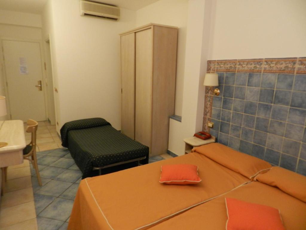 a small room with two beds and a table at Hotel Punta Mesco in Monterosso al Mare