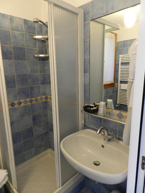 a bathroom with a sink and a shower at Hotel Punta Mesco in Monterosso al Mare