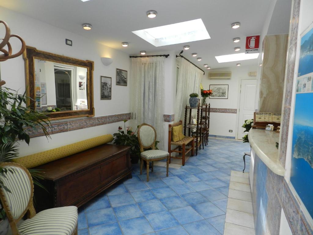 a salon with a mirror and chairs in a room at Hotel Punta Mesco in Monterosso al Mare