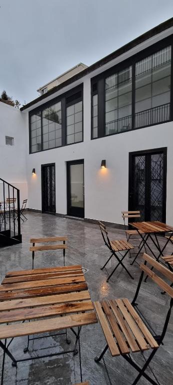 a group of benches and tables in front of a building at Kabialde Apartamentuak in Zarautz