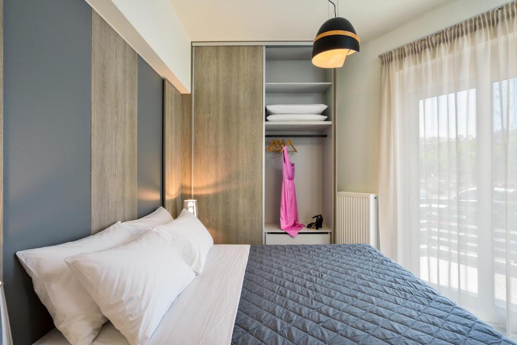 Łóżko lub łóżka w pokoju w obiekcie Elia Residences
