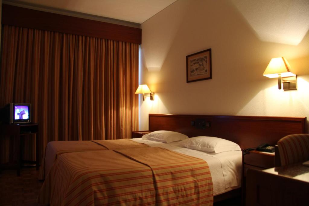 Postel nebo postele na pokoji v ubytování Hotel de Arganil