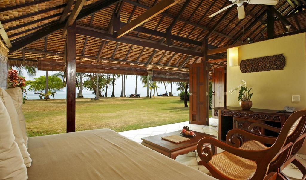 a bedroom with a bed and a view of a yard at Koyao Island Resort in Ko Yao Noi