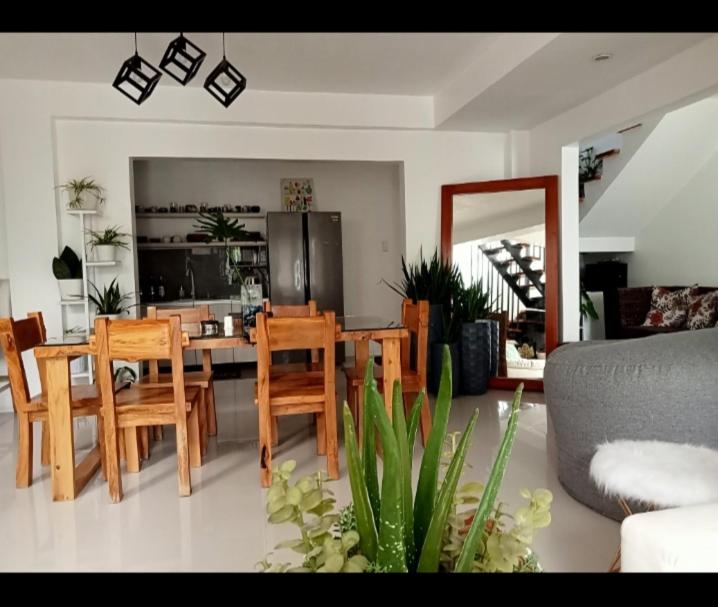 a kitchen and dining room with a table and chairs at Natalie's Villa in Iloilo City