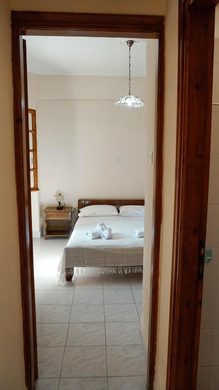 a bedroom with a bed in a room with a window at SOULA ROOMS in Kini