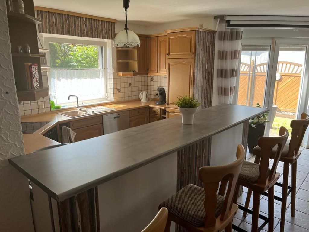 a kitchen with a counter top and some chairs at Wattenküste in Dorum