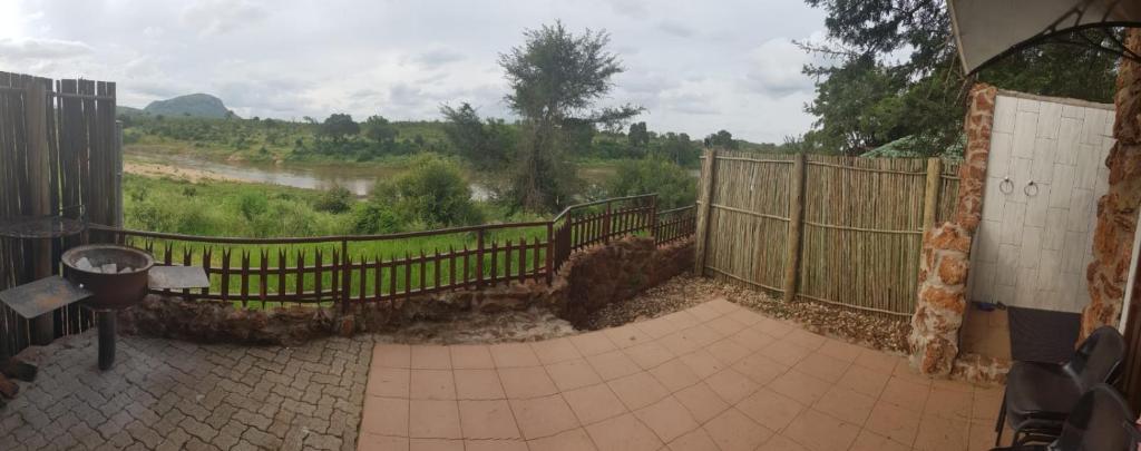 a balcony with a fence and a view of a field at Croc Lapa Chalet in Malelane