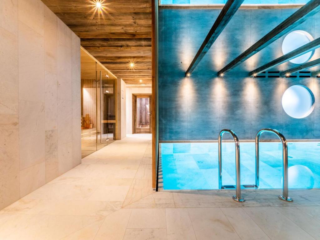 a swimming pool in the middle of a building at Mountain Home Villa Anna in Selva di Val Gardena