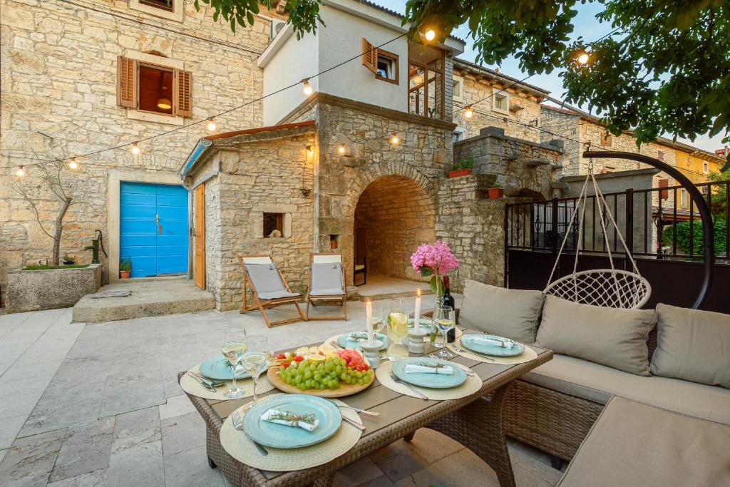 a patio with a table with food on it at Guest House Eleonora in Čabrunići