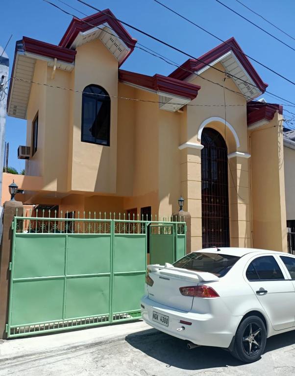 a white car parked in front of a house at Paniqui, Tarlac - Madrid in Anao