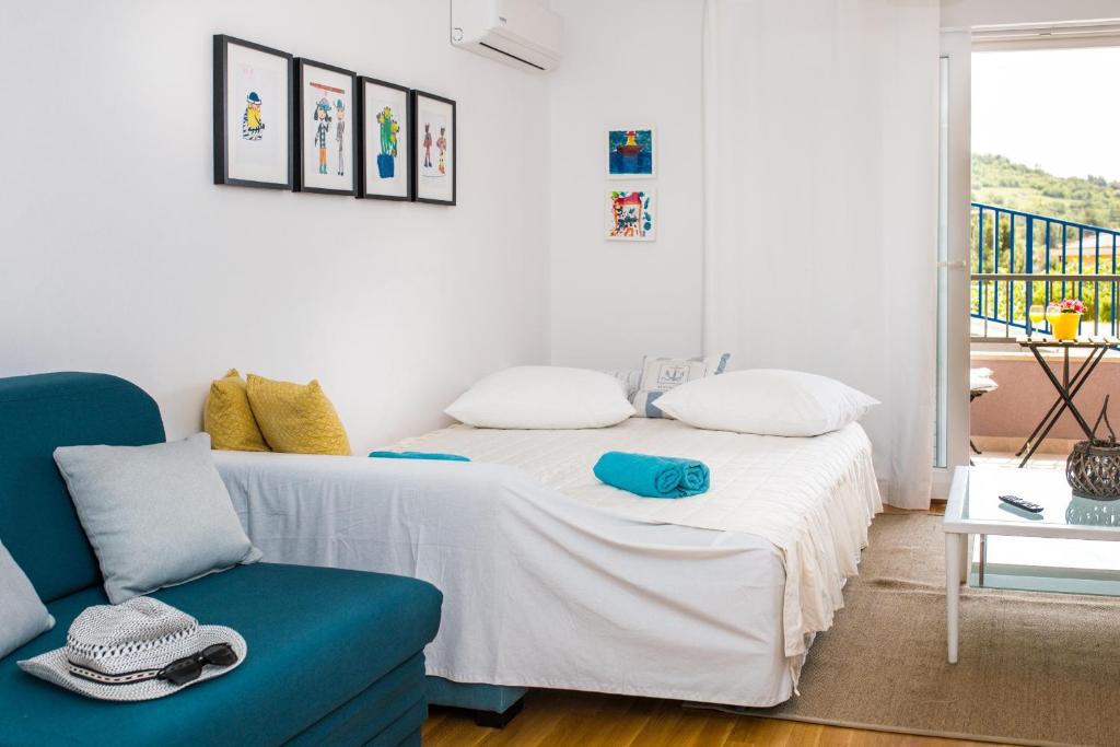 a bedroom with a bed and a blue couch at Apartment Blue Lagoon in Makarska