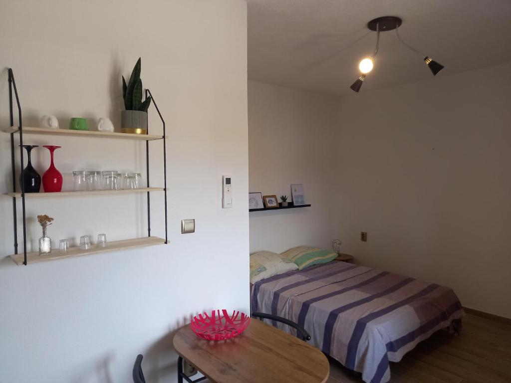 a small bedroom with a bed and a table at Apartment Karmen in Sumartin