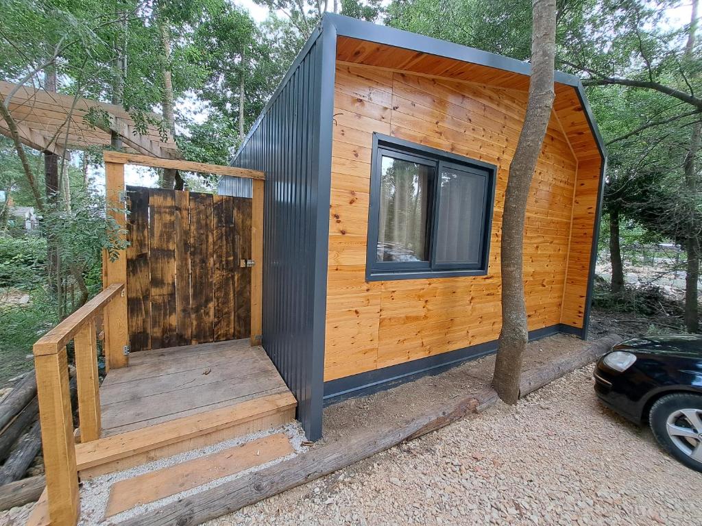 a tiny house with a staircase and a window at Vista Cottage 2 in Ulcinj