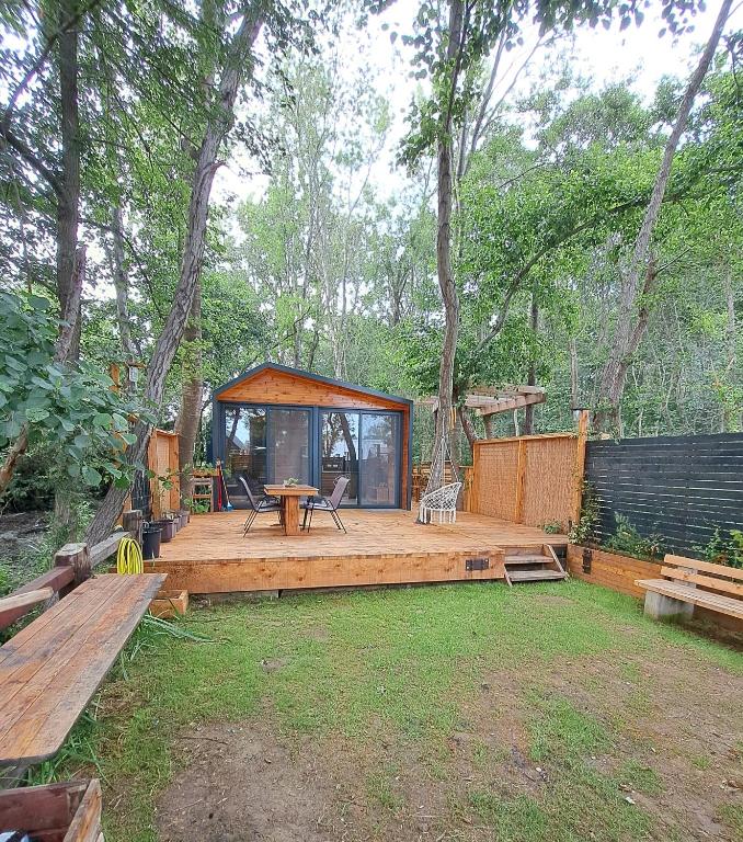a large wooden deck with a cabin in the woods at Vista Cottage 2 in Ulcinj