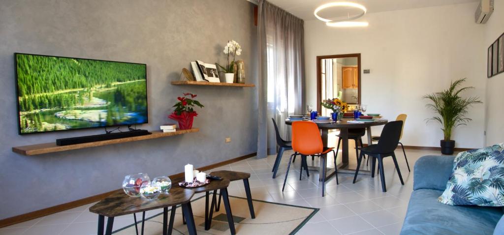 a living room with a couch and a table with chairs at Residenza Palmina in Rimini
