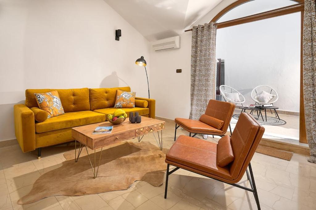 a living room with a yellow couch and a table at Luxe house in center-with terrace - Liness in Split