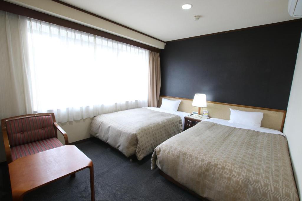 Postel nebo postele na pokoji v ubytování Hotel Aston Hotel Osaka Sakai