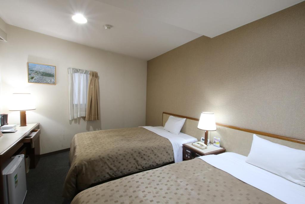Postel nebo postele na pokoji v ubytování Hotel Aston Hotel Osaka Sakai