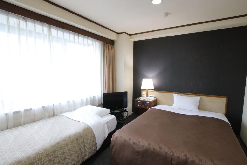 Postel nebo postele na pokoji v ubytování Hotel Aston Hotel Osaka Sakai