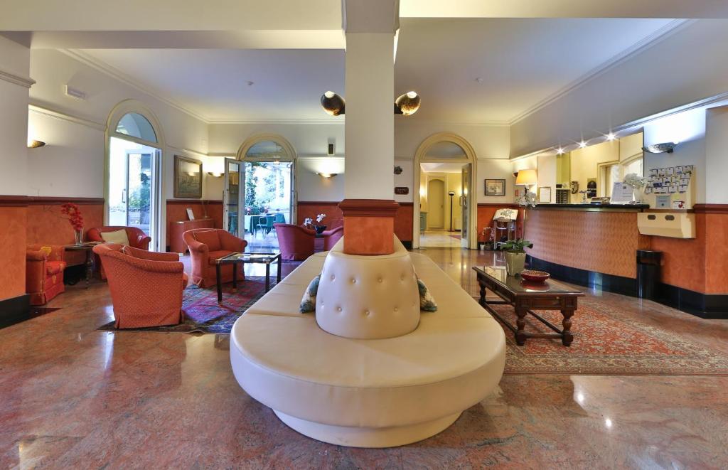 a living room with a couch in the middle of a room at Hotel Biasutti in Venice-Lido