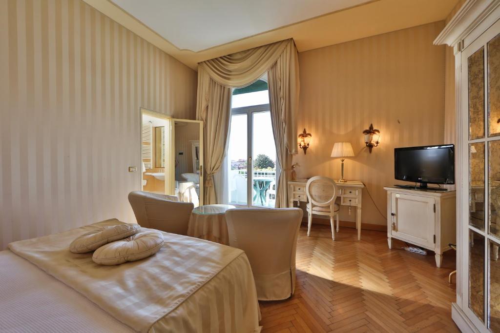 a hotel room with a bed and a television at Hotel Biasutti in Venice-Lido