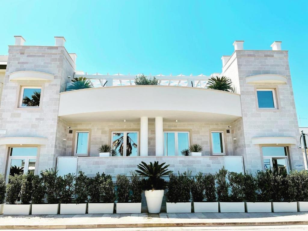 a large house with plants in front of it at La Caletta Suite Torre Canne in Torre Canne