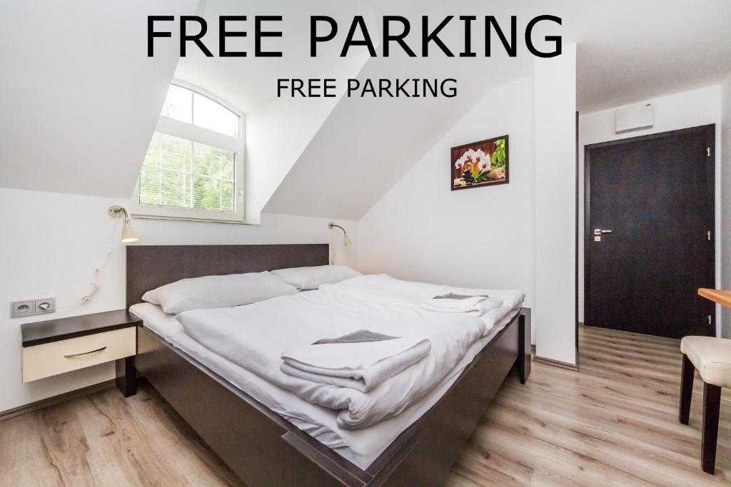 a bed in a room with the words free parking at Nová Hospoda - Hotel & Restaurant in Prague