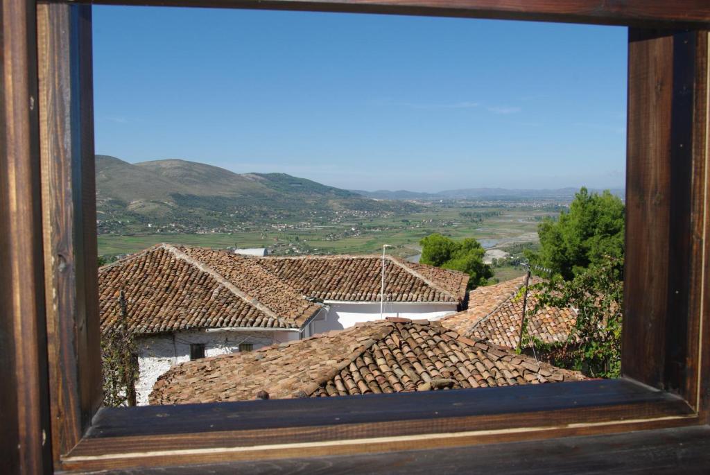 a view of roofs of houses from a window at Hotel Klea in Berat