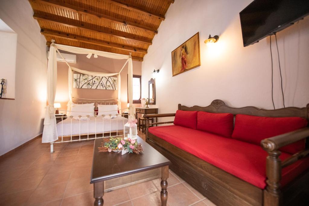 a living room with a red couch and a table at Hovolo Hotel Apartments in Neo Klima