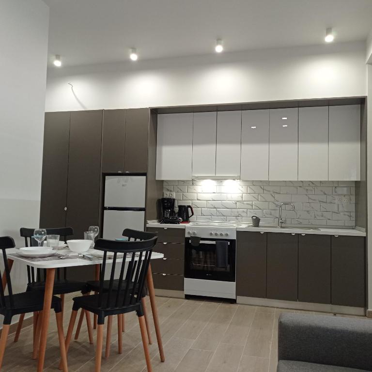 a kitchen with a table and chairs and a stove at Partcon Studio in Private Property A in Neoi Epivates