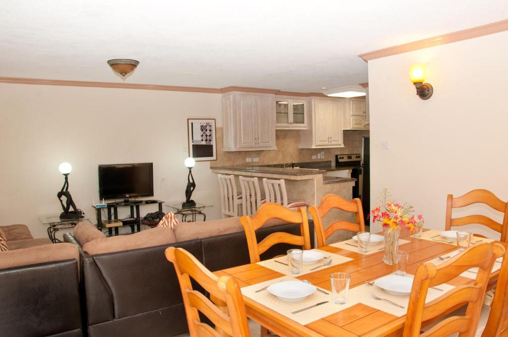 a living room with a table and a couch at Sandy Bliss Condominiums in Saint James