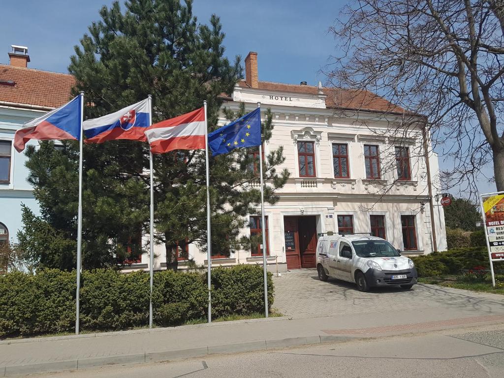 um grupo de bandeiras em frente a um edifício em Hotel Drnholec em Drnholec
