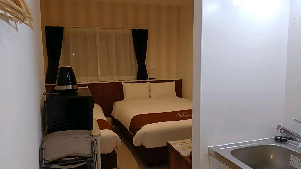 Postel nebo postele na pokoji v ubytování Living Inn Nahakoumae