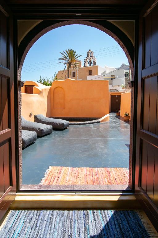a view from the window of a room with a pool at Azalea Houses Cave Villa in Oia