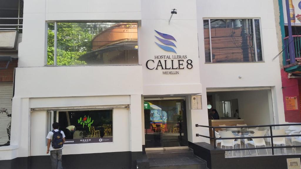 a man standing in front of a building at Hostal Lleras Calle 8 in Medellín