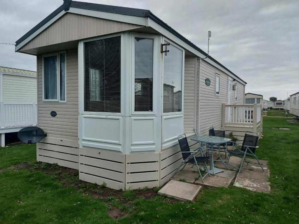 a house with a table and chairs in a yard at Park View in Winchelsea