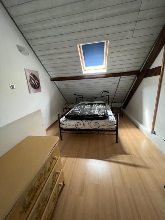 a attic bedroom with a bed in a attic at APPARTEMENT 6 PERSONNES CLASSE 2 ETOILES LEBOUCQ Laurent in Fort-Mahon-Plage