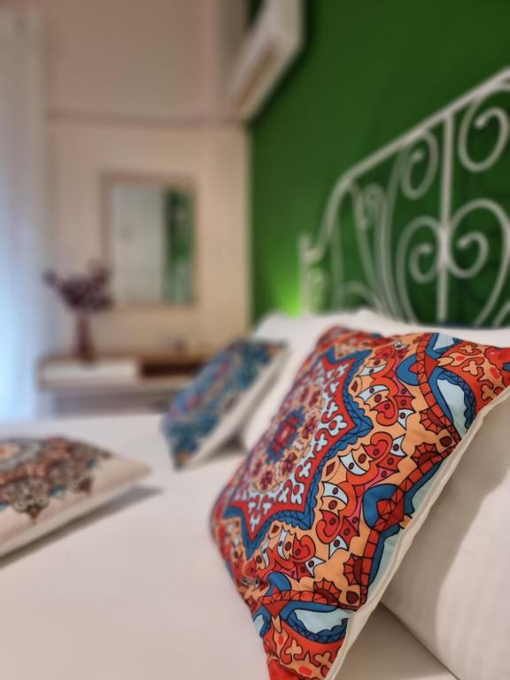 a bed with a patterned pillow on top of it at Charming Vólos House 2 in Volos